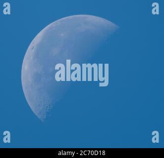 13th July 2020. Waning crescent daytime moon, 45% illuminated, photographed above London, UK Stock Photo