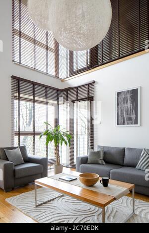 Stylish living room with big windows in two floor apartment Stock Photo