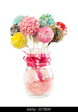 Colorfull cake pops with decorative sprinkles in glass vase isolated on white background Stock Photo