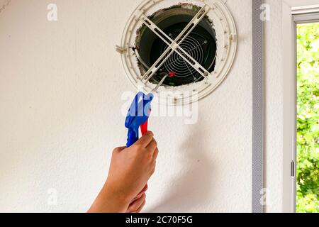 Clean the fan of the ventilation system from dust with compressed air Stock Photo