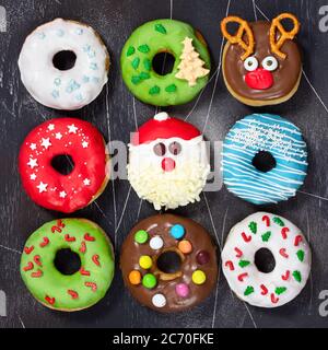 Set of Christmas donuts on dark gray stone background. Christmas and New Year celebration concept. Top view. Stock Photo