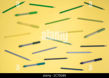 Stationery on yellow. Flat lay. Rows of tools, pastel gradient rainbow colors. Stock Photo