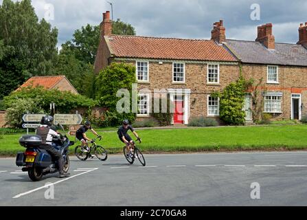 Cyclists in the village of Sutton on the Forest, Hambleton, North Yorkshire, England UK Stock Photo