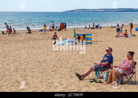 Bournemouth, Dorset UK. 13th July 2020. UK weather: warm with sunny intervals at Bournemouth beaches as a few sunseekers head to the seaside to enjoy the sunshine when the sun makes an appearance. Credit: Carolyn Jenkins/Alamy Live News Stock Photo