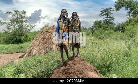 Mago National Park, Omo River Valley, Ethiopia - September 2017: Two Mursi tribe girls from Ethiopia. The women of the Mursi tribe have a lip plate an Stock Photo