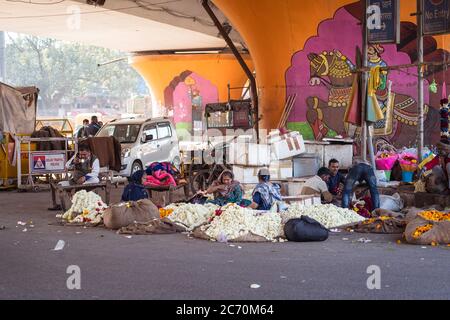 New Delhi / India - February 18, 2020: people selling flowers under a bridge in New Delhi Stock Photo