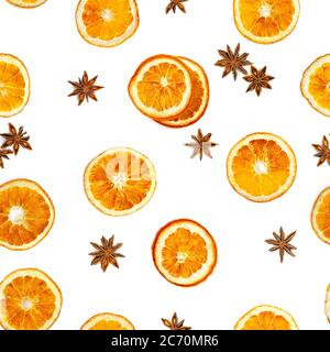 Seamless pattern with slices of dried orange and star anise isolated on white background. Stock Photo