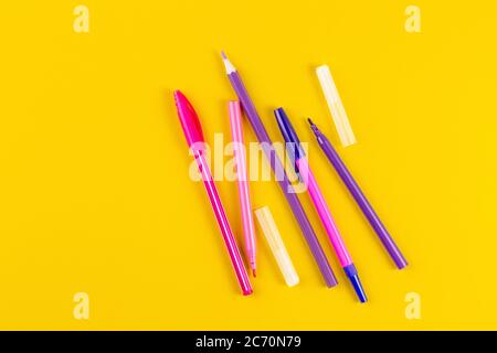 Set of colored pens on yellow paper background with copy space. Flat lay, Top view. template for design. Stock Photo