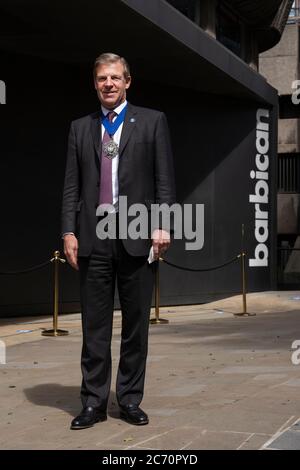 London, England. 13th July 2020. Lord Mayor of London, William Russell, outside the Barbican Art Gallery on the day it reopens its doors to the public in line with government guidelines and with new safety measures in place. The Barbican’s 2020 exhibition programme will begin again with the reopening of the acclaimed Masculinities: Liberation through Photography. All galleries and exhibition spaces have been closed for over three months in the UK due to the coronavirus (COVID-19) pandemic. (photo by Sam Mellish / Alamy Live News) Stock Photo
