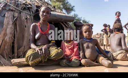 Omorate, Ethiopia - September 2017: Unidentified woman from Dassanech tribe with her children, Ethiopia Stock Photo