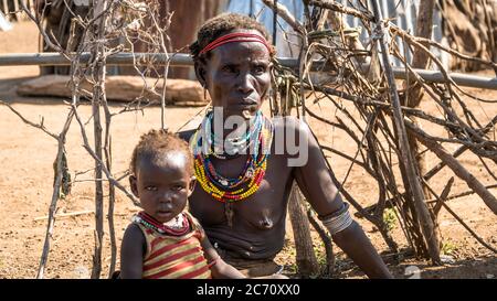 Omorate, Ethiopia - September 2017: Unidentified woman from Dassanech tribe with her child, Ethiopia Stock Photo