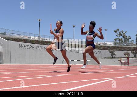 Allyson Felix takes the handoff from Tianna Bartoletta on the anchor leg of the United States women's 3 x 100m relay that won in 32.25 during the Zuri Stock Photo