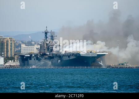 San Diego, United States. 13th July, 2020. Port of San Diego Harbor Police Department boats combat a fire onboard USS Bonhomme Richard (LHD 6) at Naval Base San Diego on July 12, 2020. On the morning of July 12, a fire was called away aboard the ship while it was moored pier side at Naval Base San Diego. Local, base, and shipboard firefighters responded to the fire. USS Bonhomme Richard is going through a maintenance availability, which began in 2018. Photo by Lt. John J. Mike/U.S. Navy/UPI Credit: UPI/Alamy Live News Stock Photo