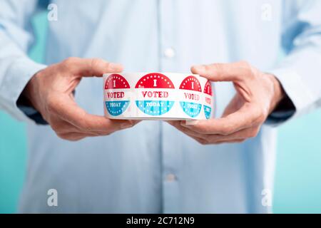Man holding I voted today stickers roll Stock Photo