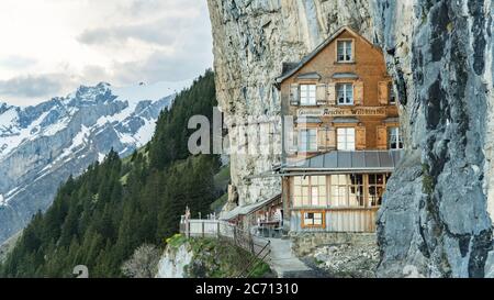 EBENALP, SWITZERLAND, May 2017: Ebenalp with its famous cliff inn Aescher. Ebenalp is an attractive recreation region for hiking, climbing, skiing and Stock Photo