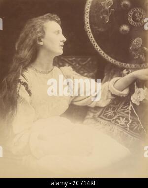 Elaine the Lily - Maid of Astolat, 1874. A seated woman (May Prinsep) in profile with long unbound hair. A photographic illustration to Alfred Tennyson's &quot;Idylls of the King&quot;; a series of narrative poems based on the legends of King Arthur. Stock Photo