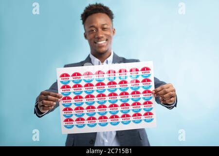 Happy smiling african voter holding stickers with I voted today Stock Photo