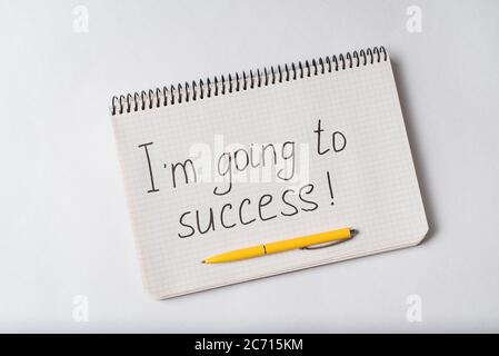 Notepad with the words Im going to success on white background. Handwritten. Stock Photo