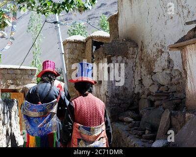 June 24: Ladakhi women in the traditional hat before the monastery in Alchi are praying, the Indus valley, India, Asia. Stock Photo