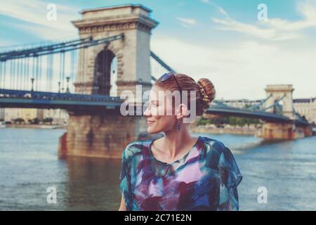 Young redhead woman posing at Chain Bridge, Lanchid, Budapest, Hungary Stock Photo