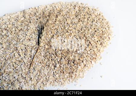 Porridge oat flakes on white background. whole oats isolated on a white background. Healthy Eating concept-Oat Flakes. Stock Photo