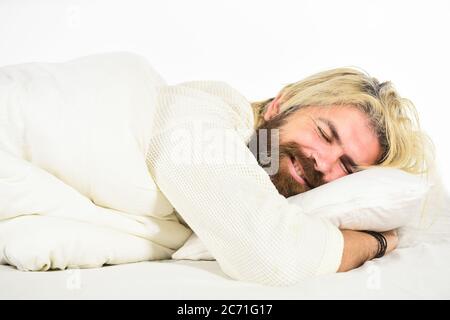 Mental health. Practice relaxing bedtime ritual. Man with sleepy face lay on pillow. Fast asleep concept. Man with beard relaxing. Having nap. Sweet dreams. Hipster with beard fall asleep. Good night. Stock Photo