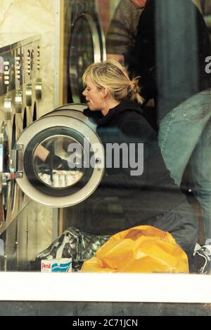 Zoe Ball tv and radio present washes her clothes in a launderette in London 1997 Stock Photo