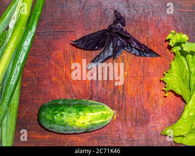 Kitchen cutting board and vegetables for salad. Stock Photo