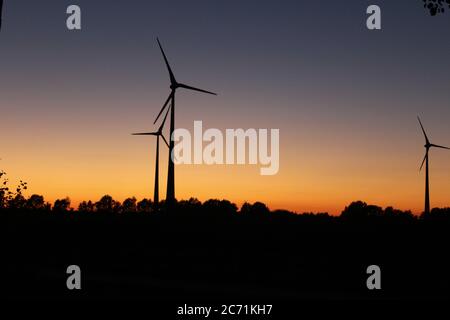 Wind turbines in the sunset near Scheeßel, Lower Saxony, Germany Stock Photo