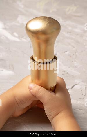 Holding Gold Light Bulb in bulb holder, Vertical photo Stock Photo
