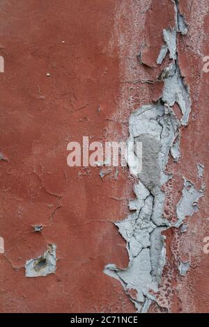 Old flaky cracked paint on gray wall, old paint background, selective focus Stock Photo