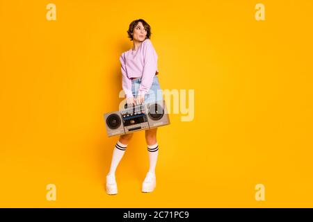 Full length body size view of her she nice attractive lovely girlish funny dreamy shy girl carrying boombox having fun pout lips posing isolated on Stock Photo