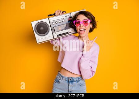 Portrait of her she nice attractive lovely girlish funny crazy cheerful cheery glad girl carrying boombox having fun showing horn sign isolated on Stock Photo