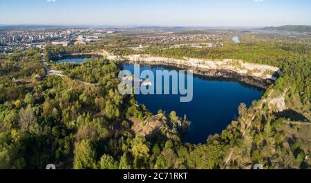 Krakow, Poland. Zakrzowek lake with steep cliffs in place of former flooded limestone quarry in Twardowski Rocks. Popular recreational place. Aerial p Stock Photo