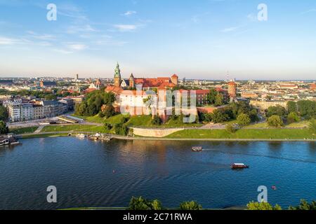 Royal Wawel Cathedral and castle in Krakow, Poland. Aerial view in sunset light. Vistula River, tourist boats, canoes, riverbank with park. promenade Stock Photo