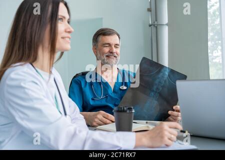 Medical Team Discussing Treatment Options With Patients. Team of doctors having a meeting in the meeting room. Stock Photo