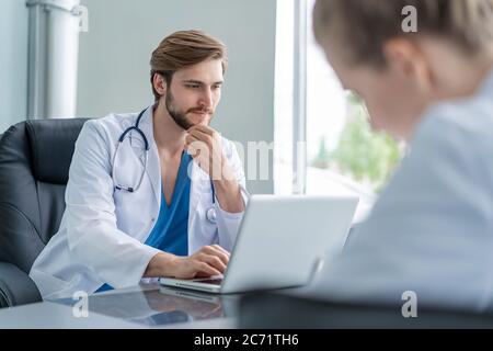 Medical Team Discussing Treatment Options With Patients. Team of doctors having a meeting in the meeting room Stock Photo