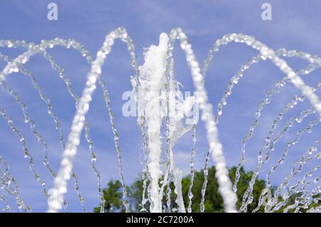 jets of water against the blue sky. summer fountain. selective focus. Stock Photo