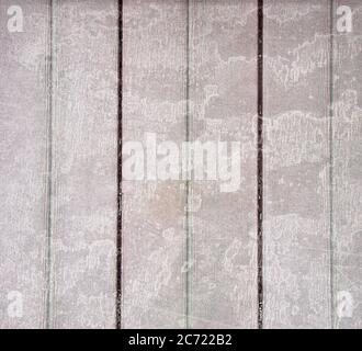 Wood floor stained background with water marks and the ridges in hues of pale green and burgundy.  Has some stains, scratches and wear and tear on the Stock Photo