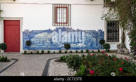Lisbon, Portugal - April 2018: Typical mural with fighting scene, made of blue tiles, at Alfamo district Stock Photo
