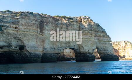 The iconic natural arch of Praia da Marinha in Algarve, Portugal, Europe view from popular boat cave tour along Algarve coast. Marinha Beach is one of Stock Photo