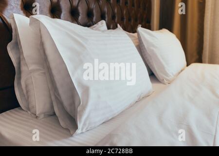 Soft white pillows on comfortable bed, closeup Stock Photo