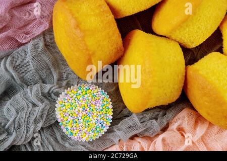 Vanilla plain cupcakes with sugar sprinkles. Close up. Stock Photo