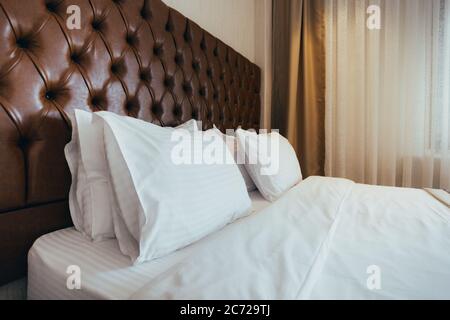 Soft white pillows on comfortable bed, closeup Stock Photo