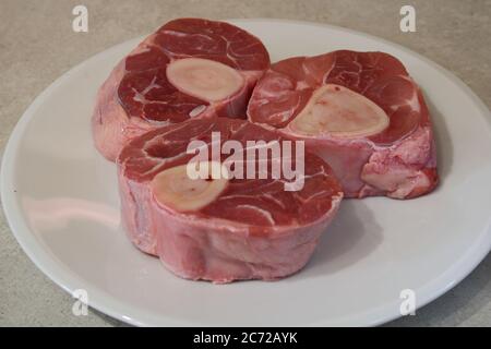 Raw white meat. Veal shank with bone marrow in the middle. Carnassist food containing energy. Not greasy. Preparation for osso bucco. Stock Photo