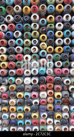 Wall of colored spray cans stacked together Stock Photo