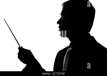 Young man in suit and tie shows pointer forward - silhouette Stock Photo