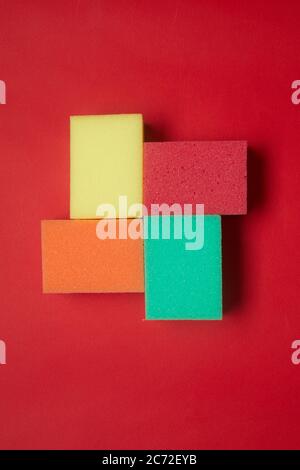 Close-up of shape made from colorful sponges isolated on red background Stock Photo