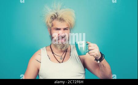 Bearded man trying to wake up in the morning after night out Stock Photo