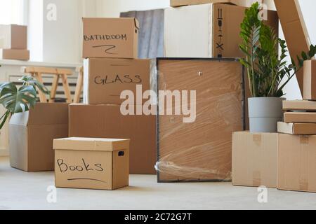 Image of heap of signed cardboard boxes in the room prepared for relocation Stock Photo
